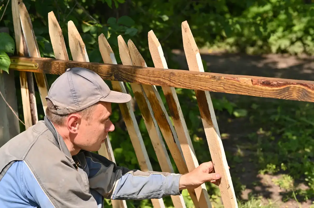 A fence being repaired by hand